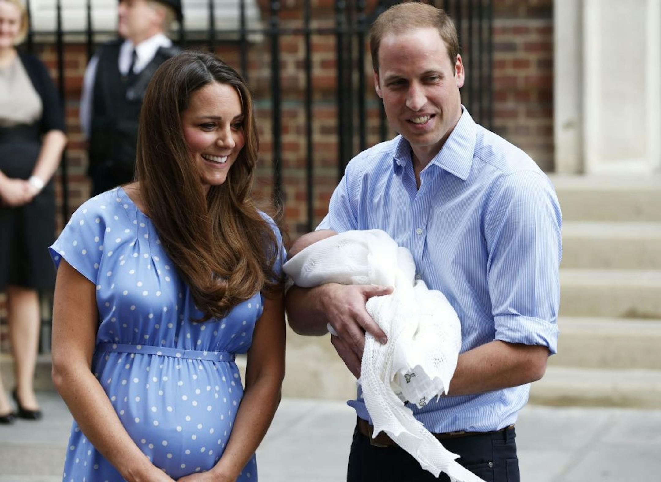 Britain's Prince William and Kate, Duchess of Cambridge hold the Prince of Cambridge, Tuesday July 23, 2013, as they pose for photographers outside St. Mary's Hospital exclusive Lindo Wing in London.