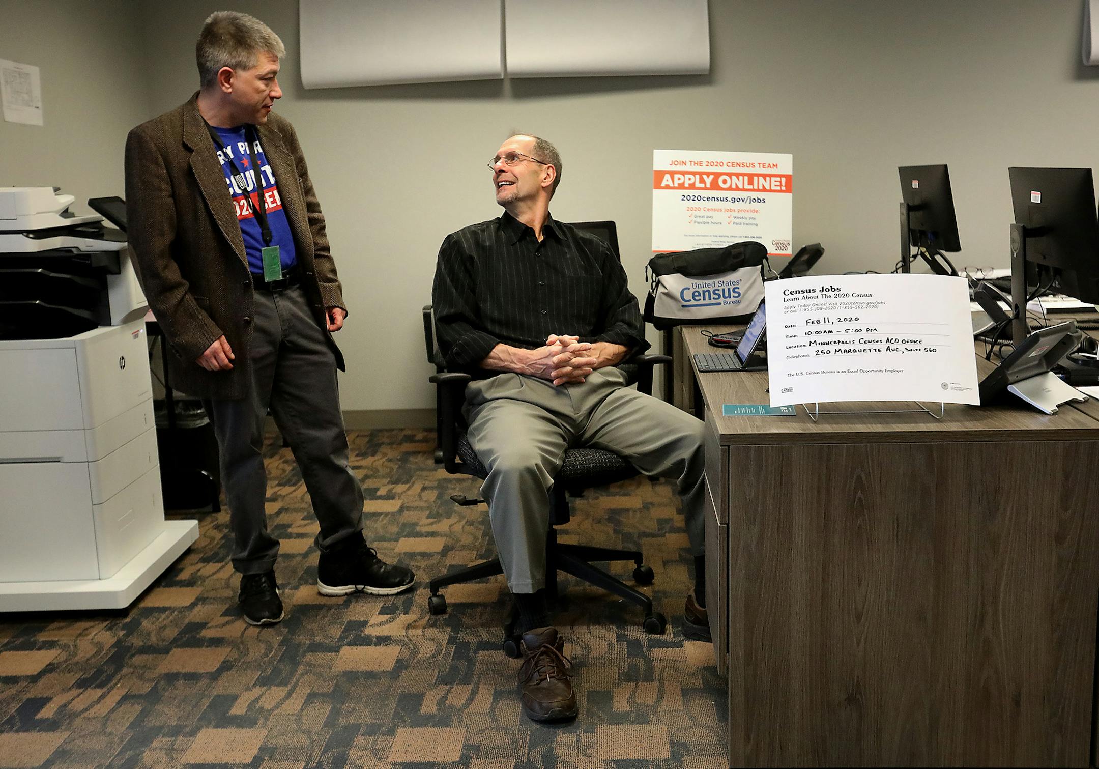 U.S. Census Bureau recruiting assistant Daniel Crawford, left, spoke with census team job applicant Lawson Brown, who was filling out an application at the Minneapolis office Tuesday, Feb. 11, 2020, in Minneapolis.