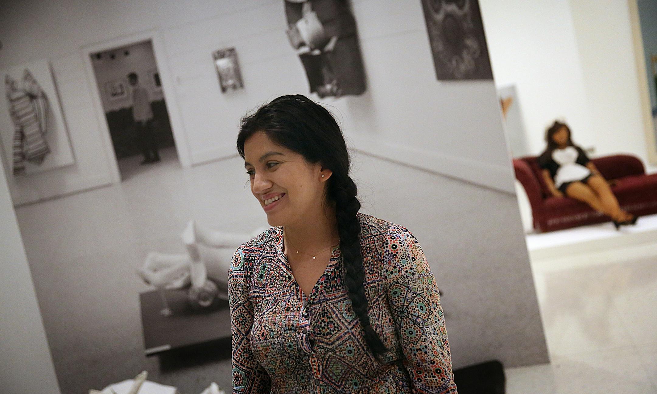Mia Lopez is a curatorial fellow for visual arts at Walker Art Center. Pieces behind Lopez include (at right): The Maid, 1966 (nylon, cotton, satin, kapok, human hair, plastic, paint) by Jann Haworth, American, born 1942; and A Load of Serious Smiles (plaster and metal) by Dalila Puzzovio, Argentine, born 1942 (lower left).