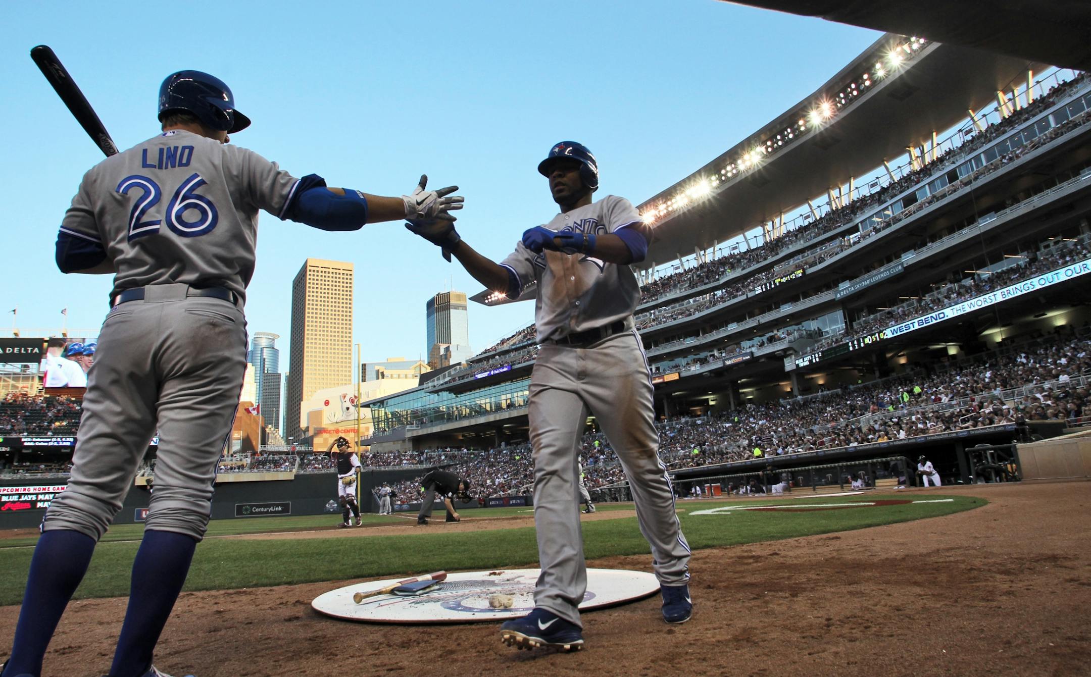 Minnesota Twins vs. Toronto Blue Jays. Toronto's Yunel Escobar, right, was congratulated by teammate Adam Lind after he scored the second Toronto run of the game in the 1st inning. (MARLIN LEVISON/STARTRIBUNE(mlevison@startribune.com