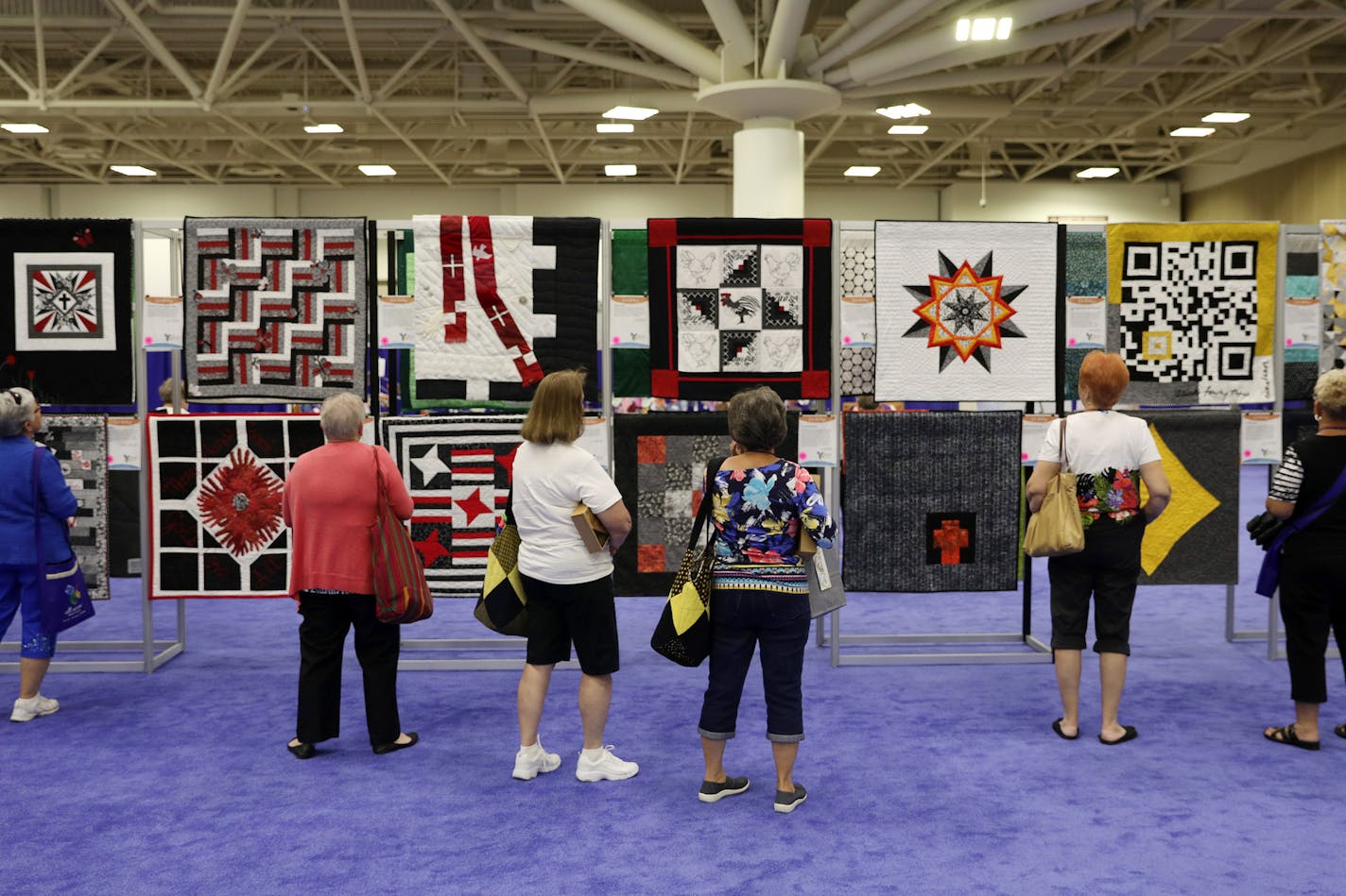 A group of women stopped to admire entries into the quilting challenge Friday. ] ANTHONY SOUFFLE &#xef; anthony.souffle@startribune.com More than 3,000 Lutheran women from across the globe gathered at the Minneapolis Convention center this week for the triennial gathering of the Women of the Evangelical Lutheran Church of America Friday, July 14, 2017 in Minneapolis.