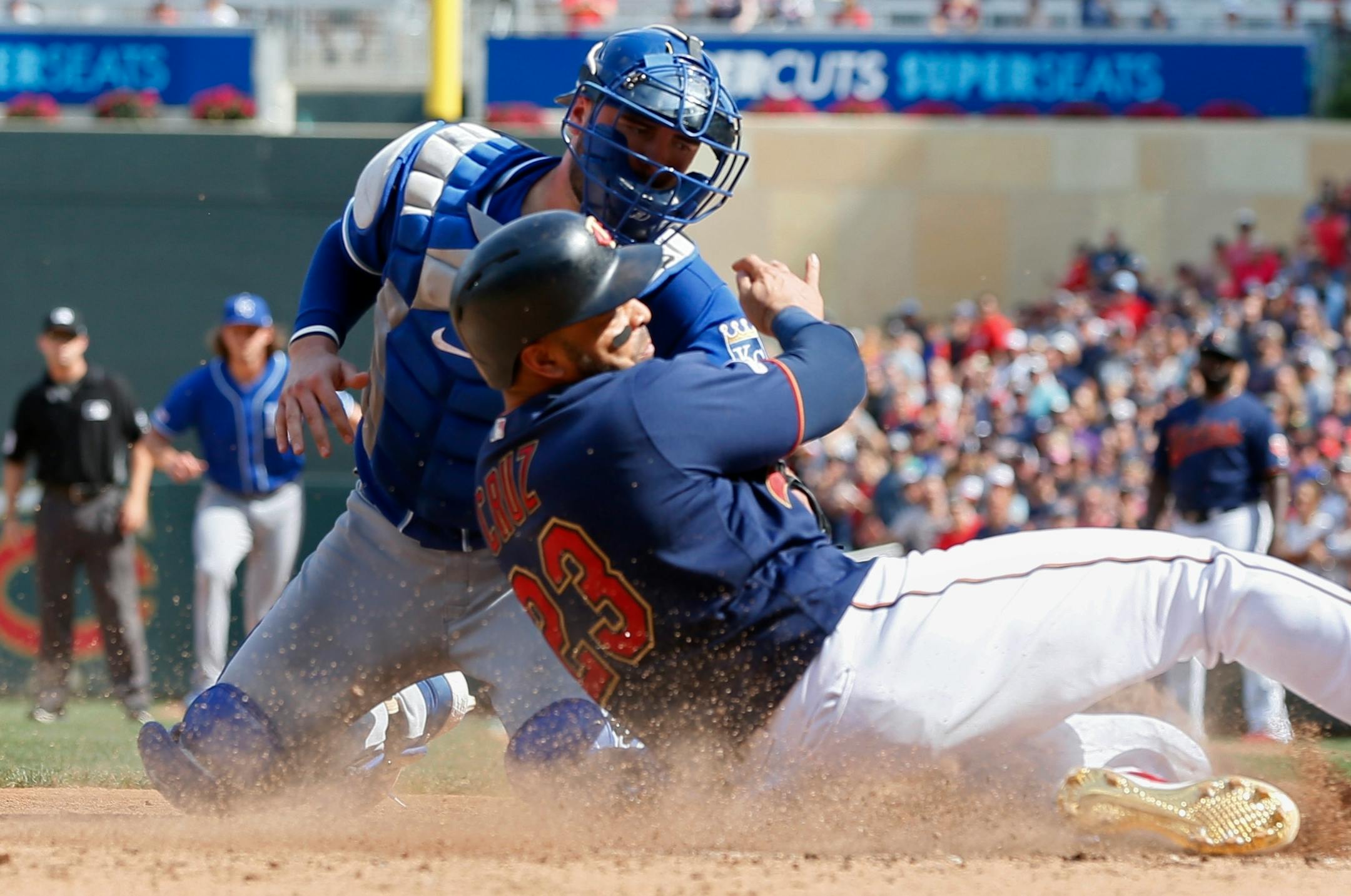 Minnesota Twins' Nelson Cruz, right, is tagged out at the plate by Kansas City Royals catcher Cam Gallagher as he tried to score from third on a single by Eddie Rosario in the eighth inning of a baseball game Sunday, Aug. 4, 2019, in Minneapolis. The Twins won 3-0. (AP Photo/Jim Mone)