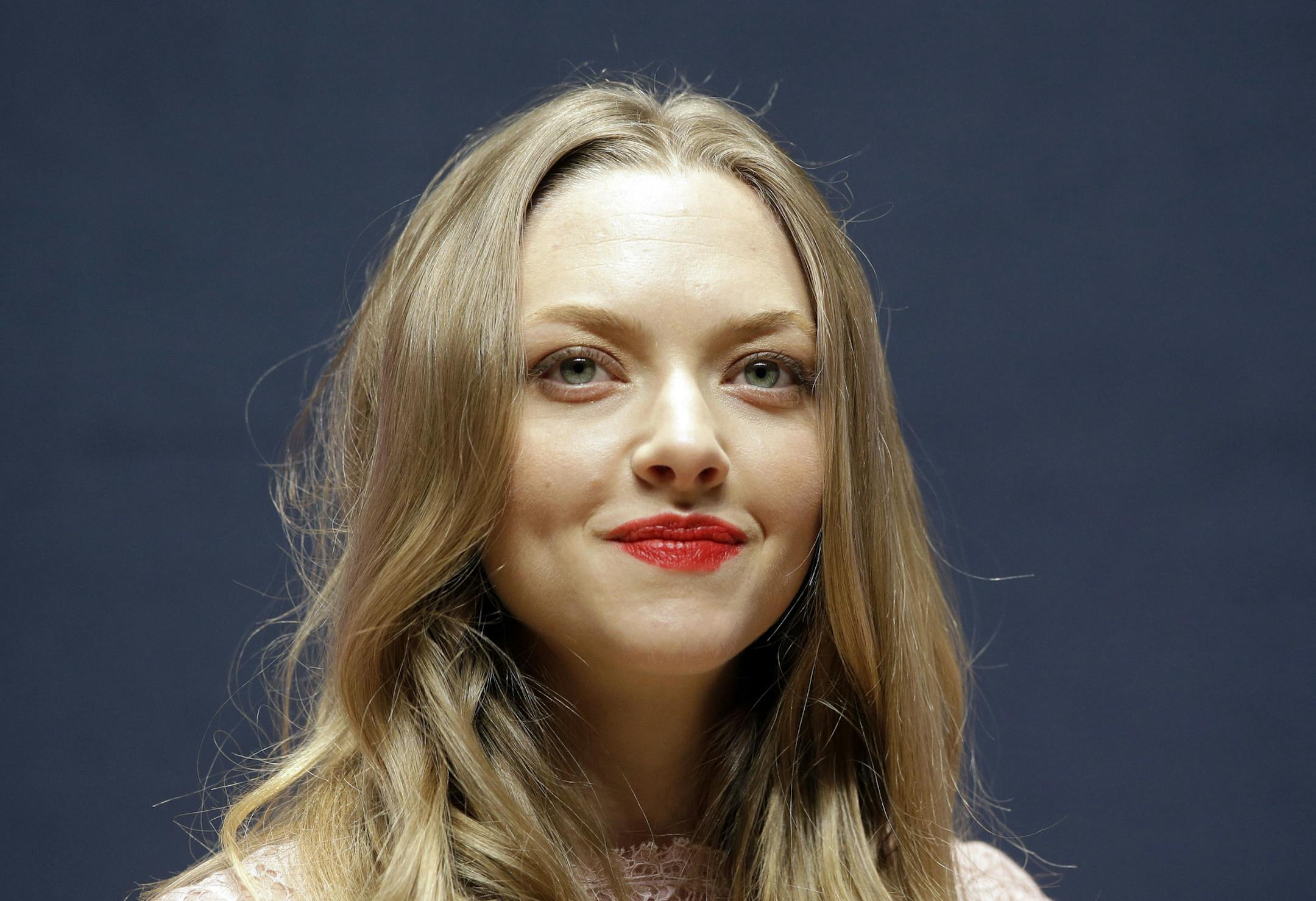 Hollywood actress Amanda Seyfried listens to a reporter's question during a press conference in Seoul, South Korea, Wednesday, Dec. 4, 2013. Seyfried arrived here, Tuesday, on a three-day visit for a commercial promotion. (AP Photo/Lee Jin-man)
