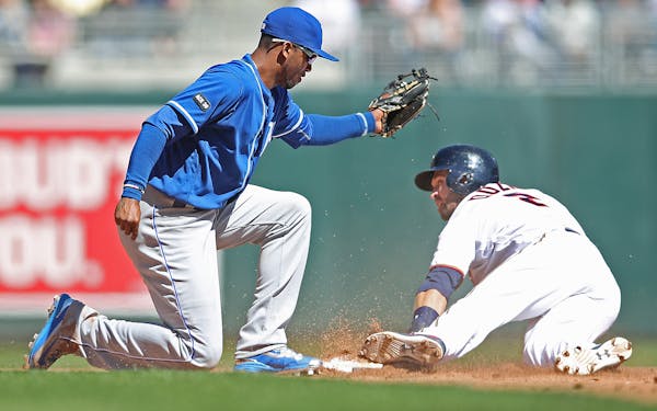 Brian Dozier beat the Royals' Alcides Escobar to second base during the fifth inning Thursday.
