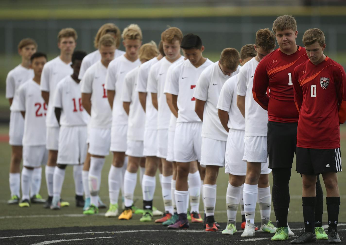 Members of the Lakeville North boys' soccer team bowed their heads for a moment of silence to honor assistant coach Seamus Tritchler and former teammate Joey Dokken.