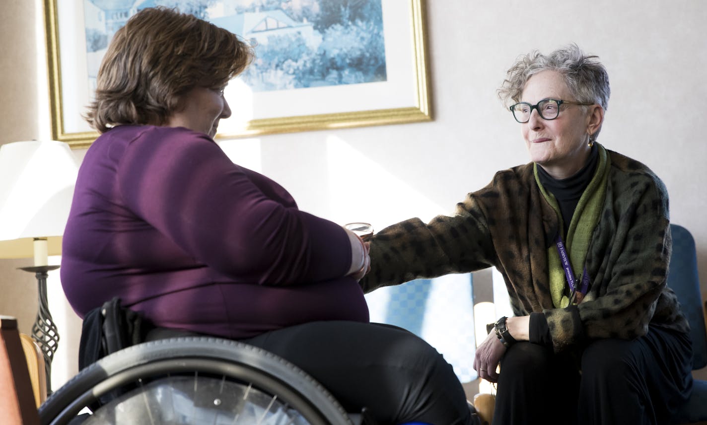 Myo-O Habermas-Scher, right, a Zen Buddhist priest, comforted patient Sue Smith at the University of Minnesota Medical Center.