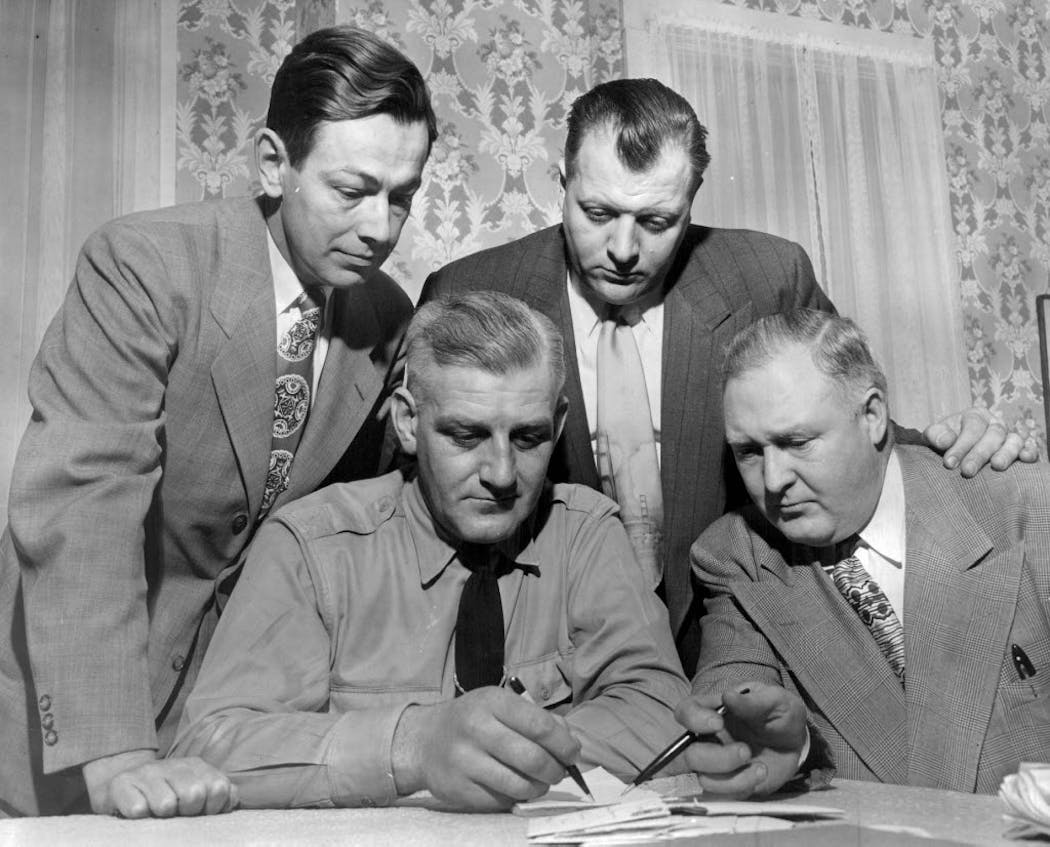 Left to right, McLeod County Attorney Hubert Smith, Sheriff Otto Guenhagen, and Minneapolis attorneys Frank Warner and Don Morgan conferred on the Jones murder case. 