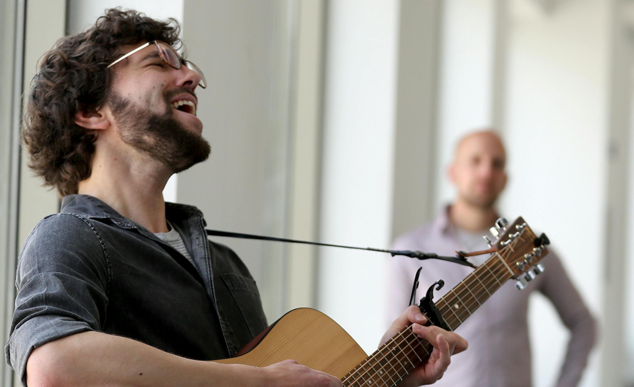 Local musician Ross Hackenmiller gave the first in a series of free concerts in the skyway above the Green Line's Central Station in downtown St. Paul Wednesday, May 3, 2017, in St. Paul, MN. The Wednesday concerts will be paired with donut offerings in the skyway on Monday and Friday mornings through May. "My name is Ross and I like to play guitar," he told a group passing in the skyway, adding that he was also a member of the local band Filthy Animals.] DAVID JOLES ï david.joles@startribu
