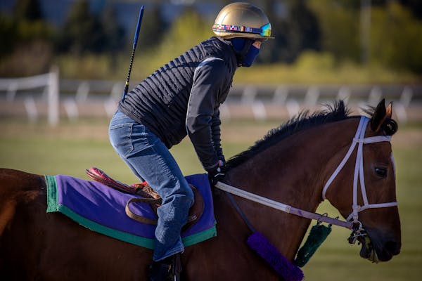 Leslie Mawing was one of the first exercise riders on the track as Canterbury Park opened for training Tuesday. He wore a mask, as required by everyon