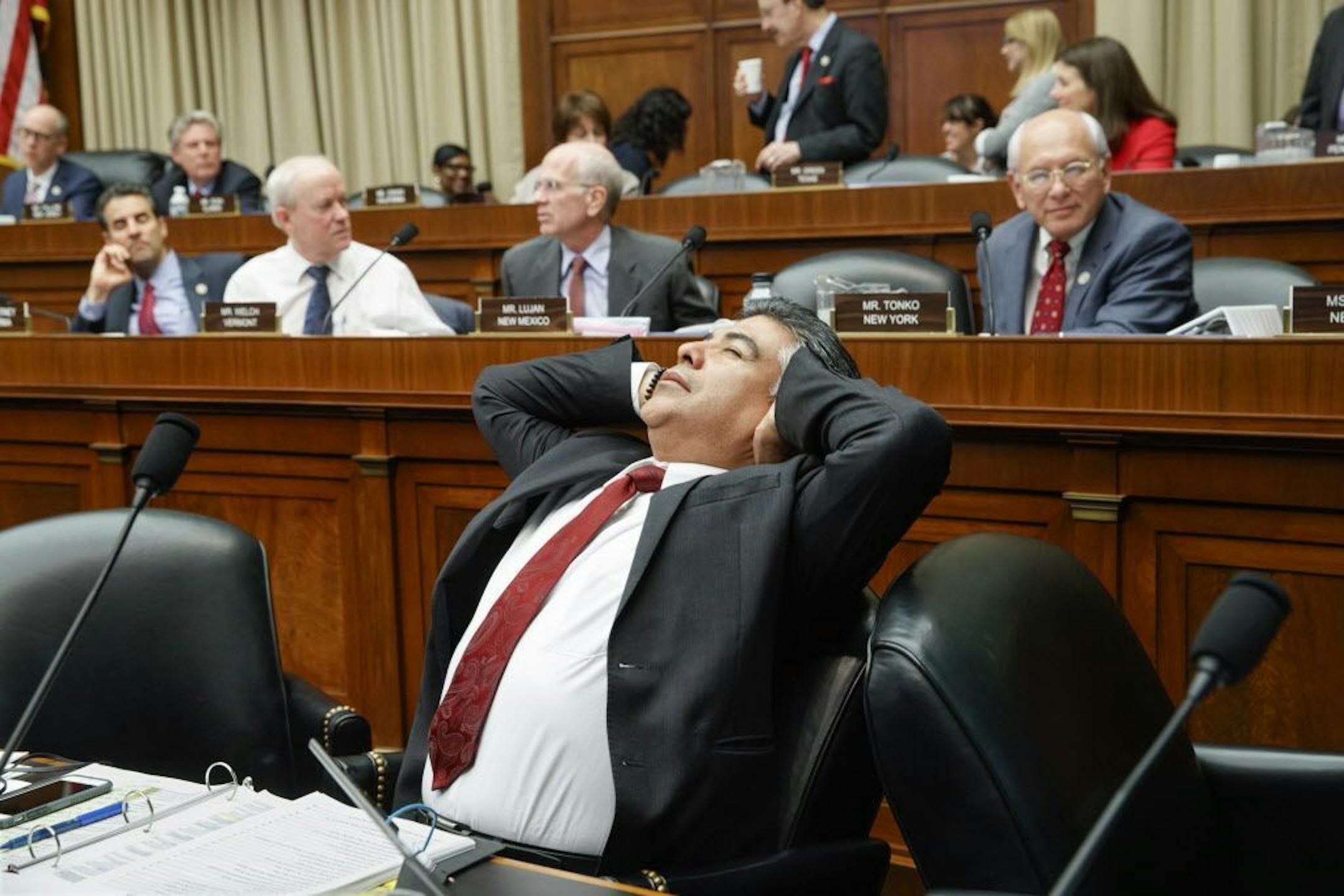 After working through the night, House Energy and Commerce Committee member Rep. Tony Cardenas, D-Calif., stretches while members of the committee argue the details of the GOP's "Obamacare" replacement bill, Thursday, March 9, 2017, on Capitol Hill in Washington.