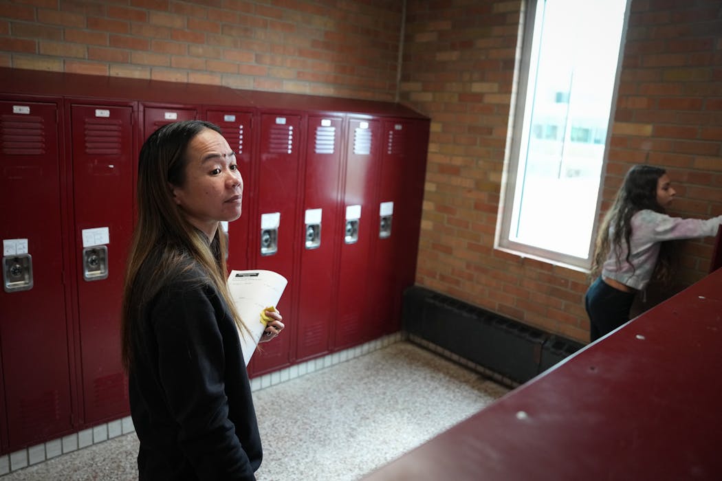 Teacher Narene Canindo makes sure her students take what they need from their lockers at the end of a school day inside Fridley Middle School in Fridley on Tuesday.