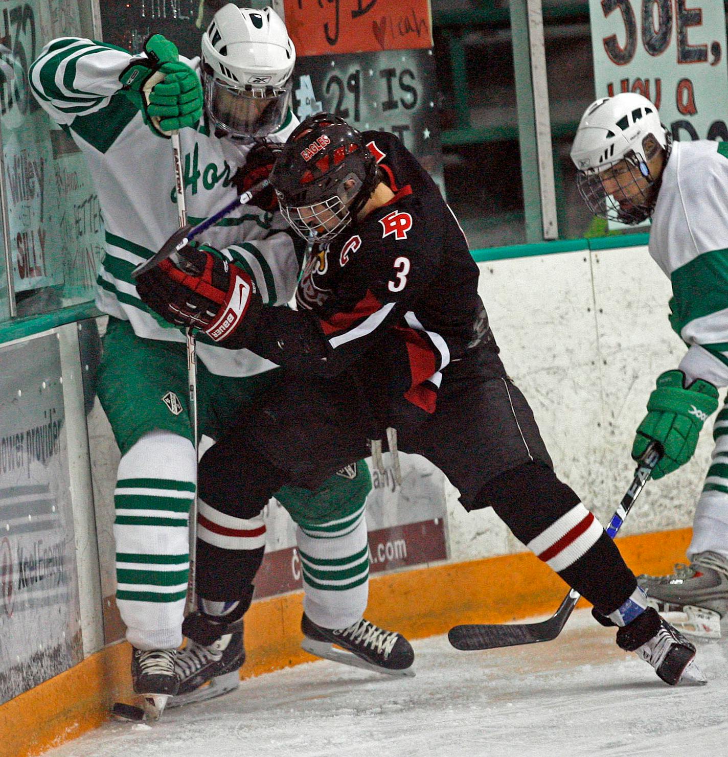 Eden Prairie's Nick Leddy (3) fought for control of the puck in a game against Edina.