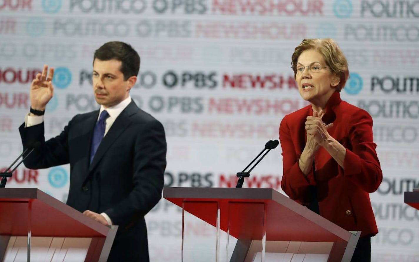 Democratic presidential candidate Sen. Elizabeth Warren, D-Mass., right, speaks beside South Bend Mayor Pete Buttigieg during a Democratic presidential primary debate Thursday, Dec. 19, 2019, in Los Angeles.