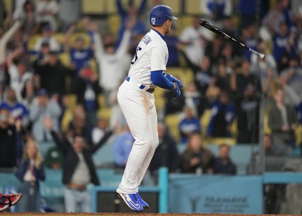 Los Angeles Dodgers' Trayce Thompson (25) tosses his bat as he walks during the twelfth inning of a baseball game against the Minnesota Twins in Los A