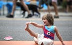 Leona Cronin 4, joined others who did a Blooma yoga morning yoga session on Lyndale Ave near Lake street during Open Streets Minneapolis on Lyndale Av