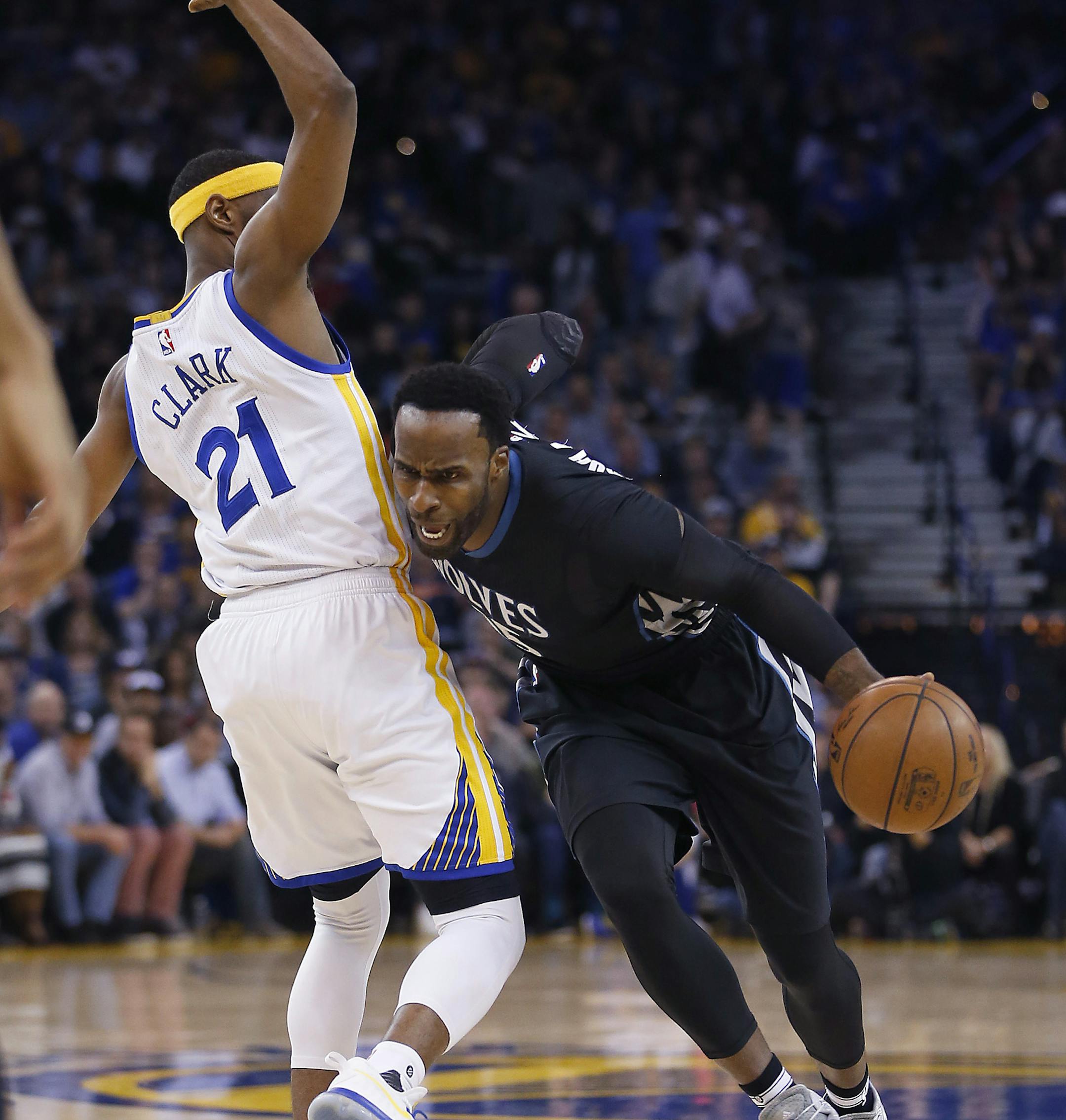 Minnesota Timberwolves forward Shabazz Muhammad (15) drives around Golden State Warriors guard Ian Clark (21) during the first half of an NBA basketball game Tuesday, April 4, 2017, in Oakland, Calif. (AP Photo/Tony Avelar)