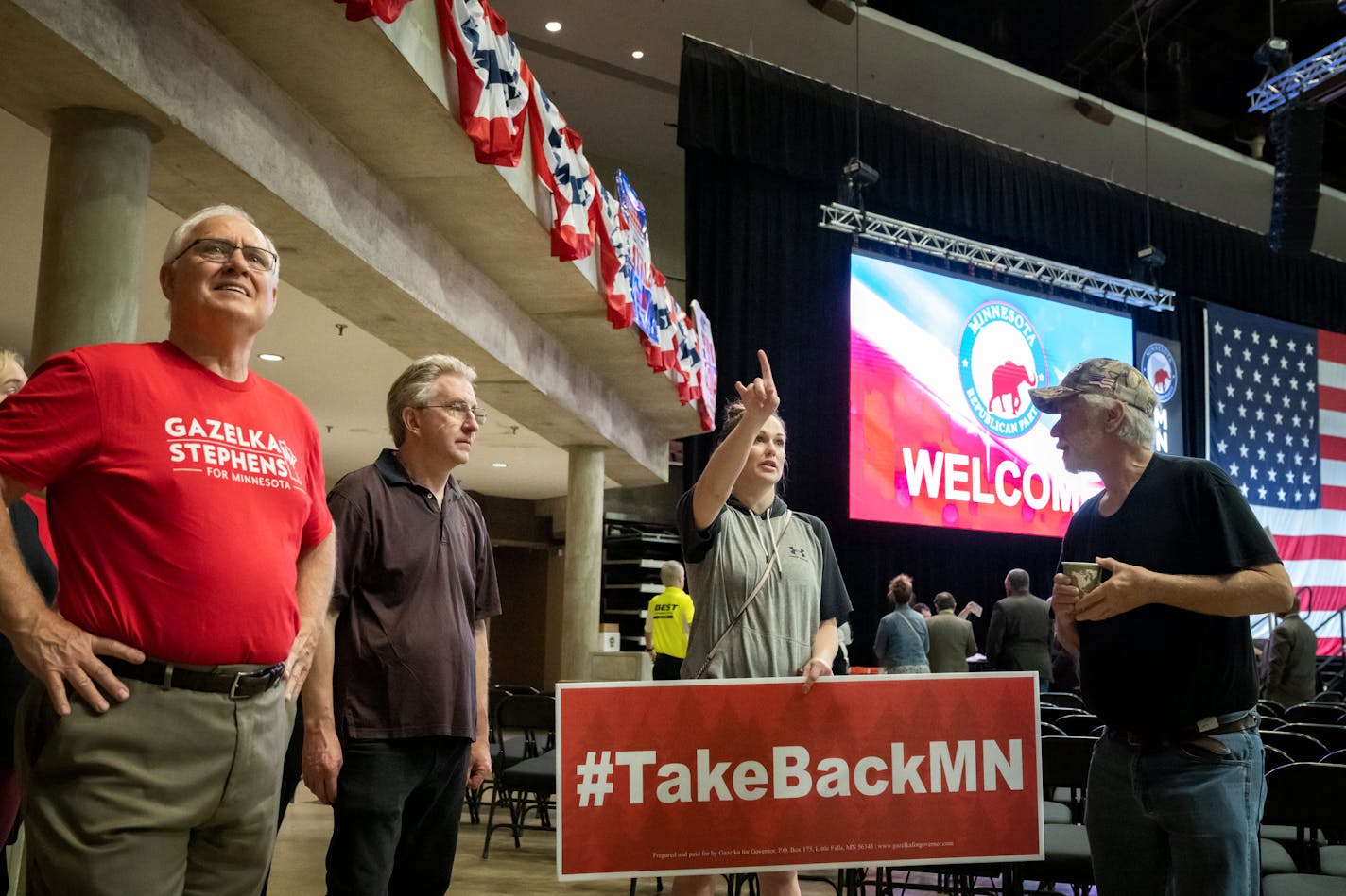 Paul Gazelka staffer Angel Zierden instructed volunteers where to hang the candidates signs and banners, Thursday, May 12, 2022 Rochester, Minn. Candidates hung signs as the stage was being prepared for this weekend's Minnesota State Republican Convention in the Mayo Civic Center. ] GLEN STUBBE • glen.stubbe@startribune.com