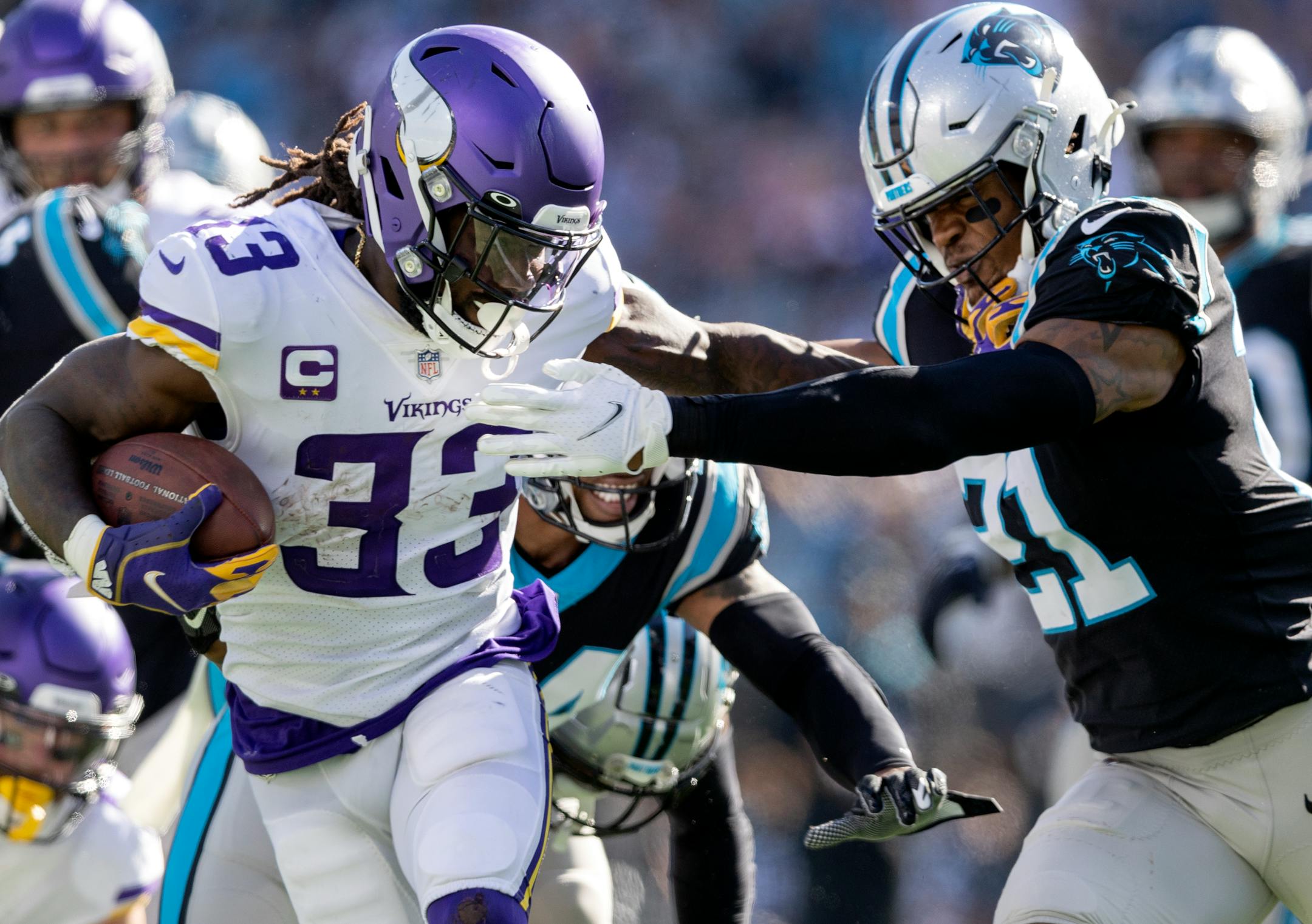 Minnesota Vikings running back Dalvin Cook (33) pushed off of Jeremy Chinn (21) of the Carolina Panthers during a touchdown run in the third quarter.