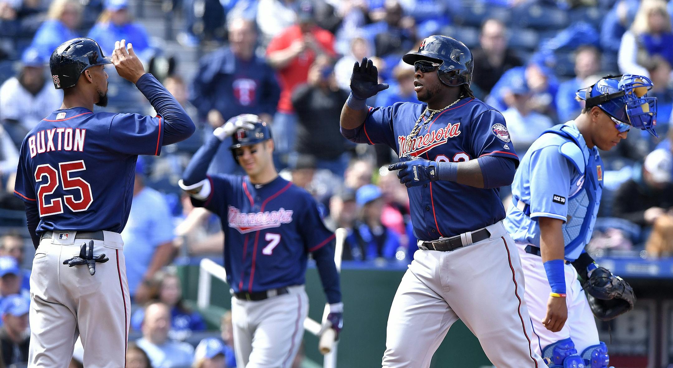 Minnesota Twins' Miguel Sano is congratulated by Byron Buxton in front of Kansas City Royals catcher Salvador Perez after Sano hit a three-run home run in the third inning on Sunday, April 30, 2017 at Kauffman Stadium in Kansas City, Mo. (John Sleezer/Kansas City Star/TNS) ORG XMIT: 1201506