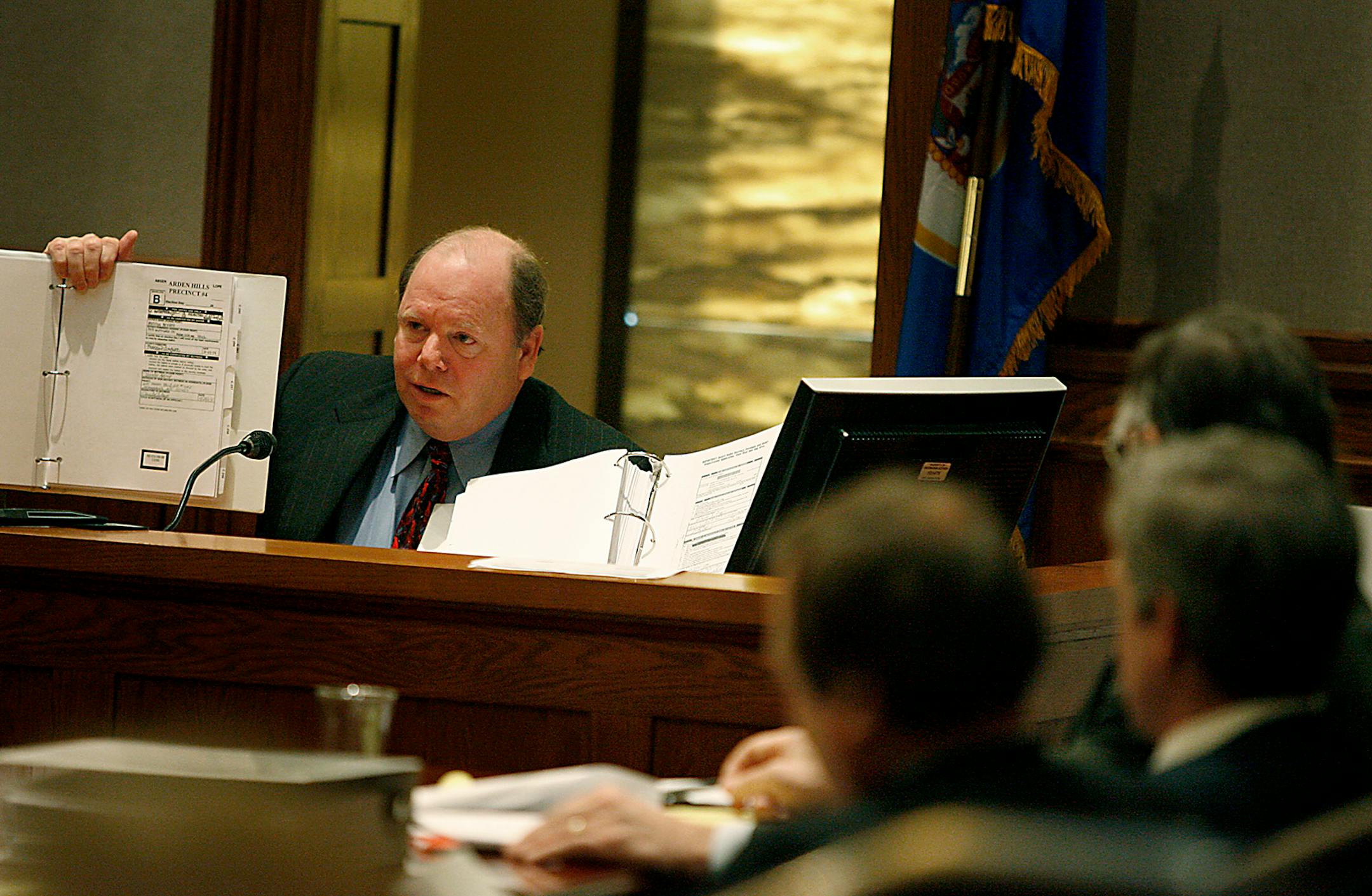 Ramsey County Elections Director Joe Mansky held up exam­ples as he explained how local election officials determine which absentee ballots have been legally cast.