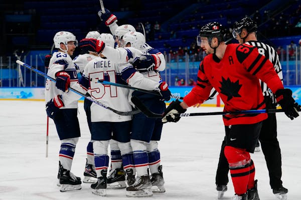 United States players celebrate after a goal by Kenny Agostino in a 4-2 win over Canada at the Olympics on Saturday. 