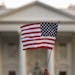 FILE - In this Sept. 2017 file photo, a flag is waved outside the White House, in Washington. The Trump administration announced Friday that it was cu