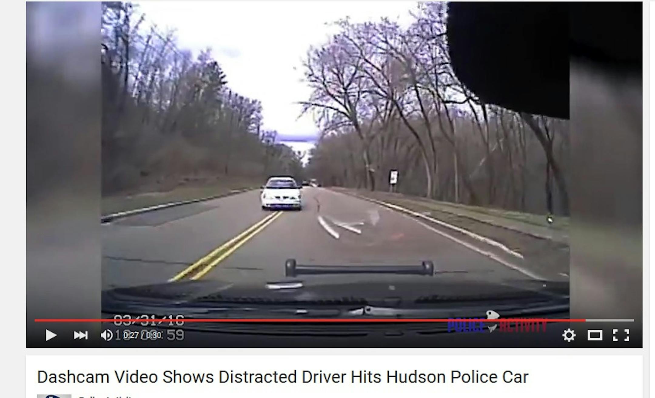 A dashcam video captures a distracted driver veering into the path of a police car.
