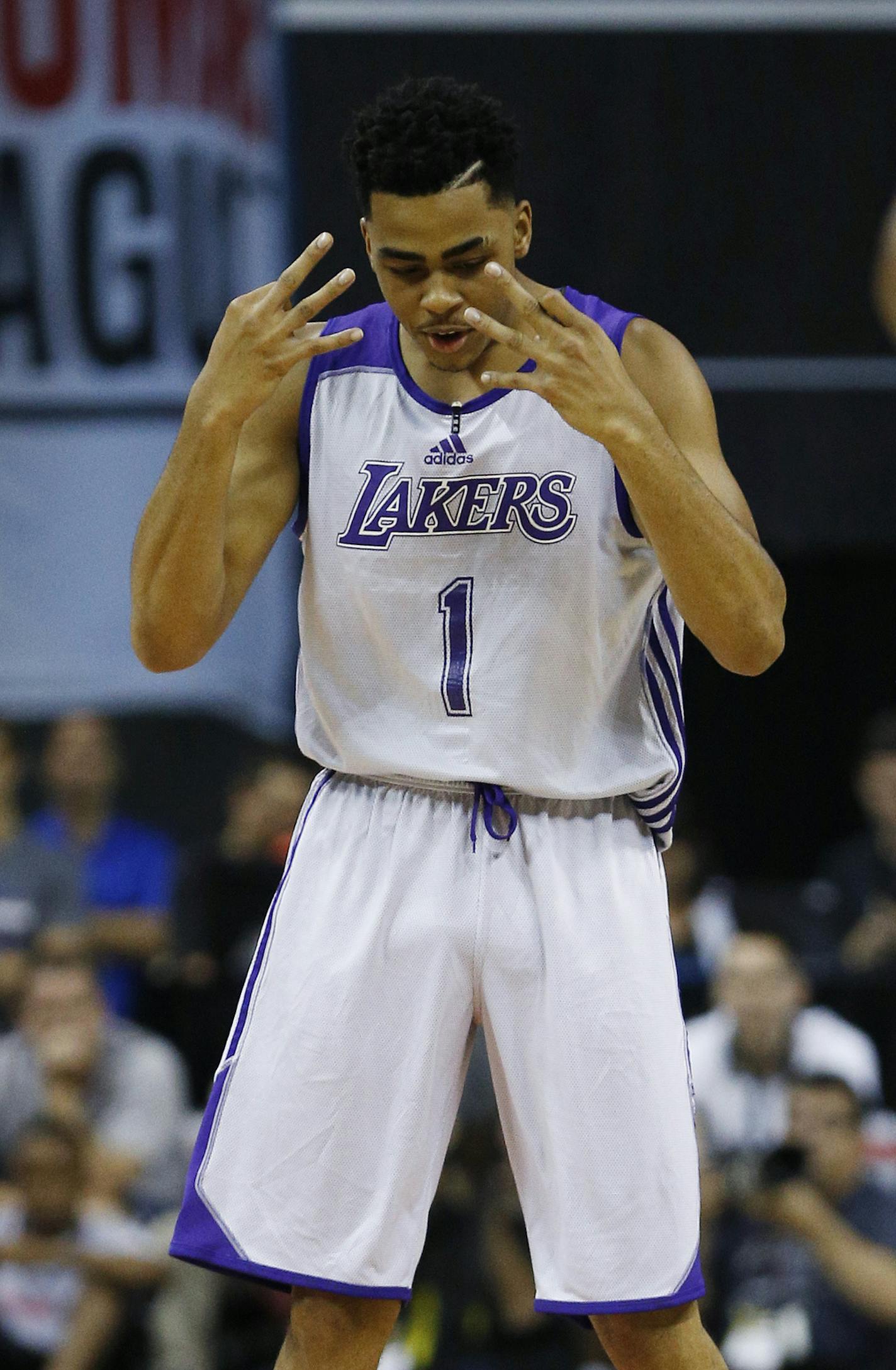 Los Angeles Lakers&#xed; D'Angelo Russell reacts after scoring against the Minnesota Timberwolves during the first half of their NBA summer league basketball game Friday, July 10, 2015, in Las Vegas. (AP Photo/John Locher)