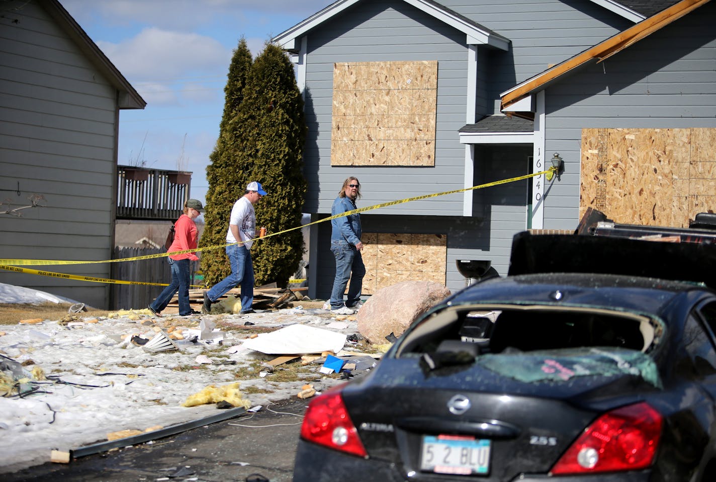 A man prepares to enter the damaged house where outside a food truck exploded in Lakeville late Friday night and was seen in the 16500 block of Joplin Path Saturday, March 7, 2015, in Lakeville, MN