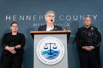 Hennepin County Attorney Mary Moriarty speaks while being flanked by attorney Siara Melius and Brooklyn Park Police Chief Mark Bruley, left to right, 