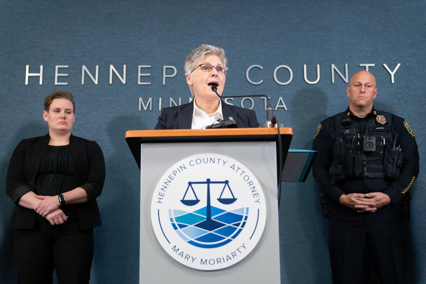 Hennepin County Attorney Mary Moriarty speaks while being flanked by attorney Siara Melius and Brooklyn Park Police Chief Mark Bruley, left to right, during a press conference discussing new requirements police chiefs will have to disclose about an officer's history of misconduct Wednesday, Jan. 03, 2024, at the Hennepin County Government Center in Minneapolis, Minn. The data is often referred to as "Brady" or "Giglio" for the legal doctrines. ]