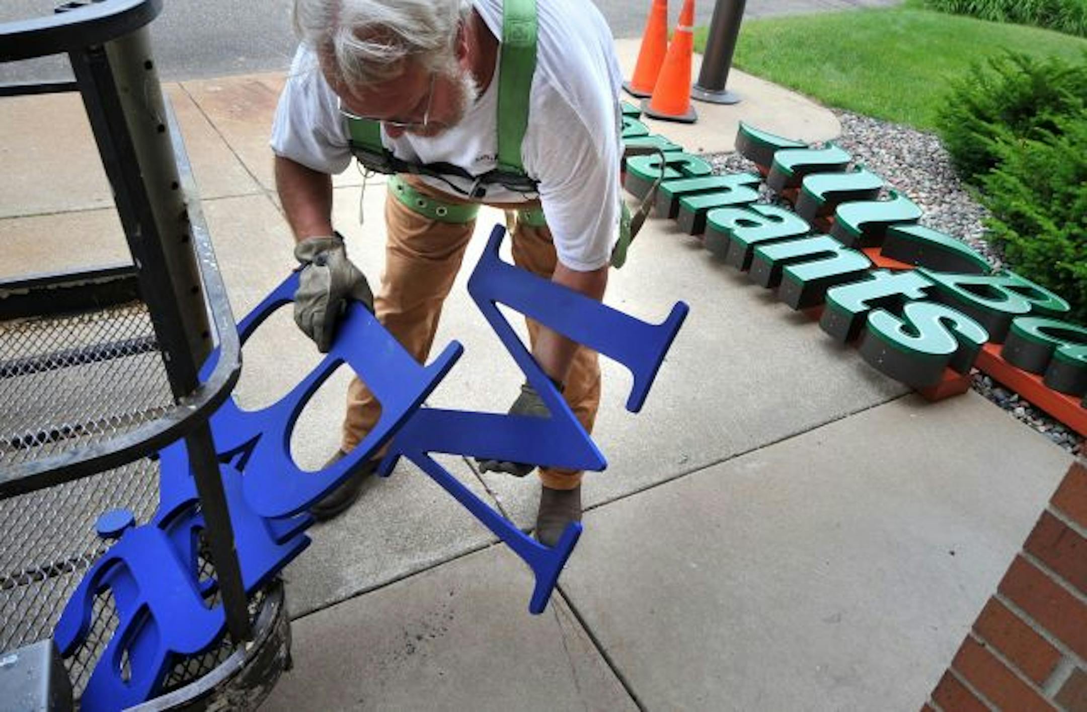 Jeff Ford of Schad-Tracy Signs gathered the letters he had just removed from the Mainstreet Bank branch in Cottage Grove and replaced it with its new Merchants Bank sign. Merchants Bank bought Mainstreet's Cottage Grove location.