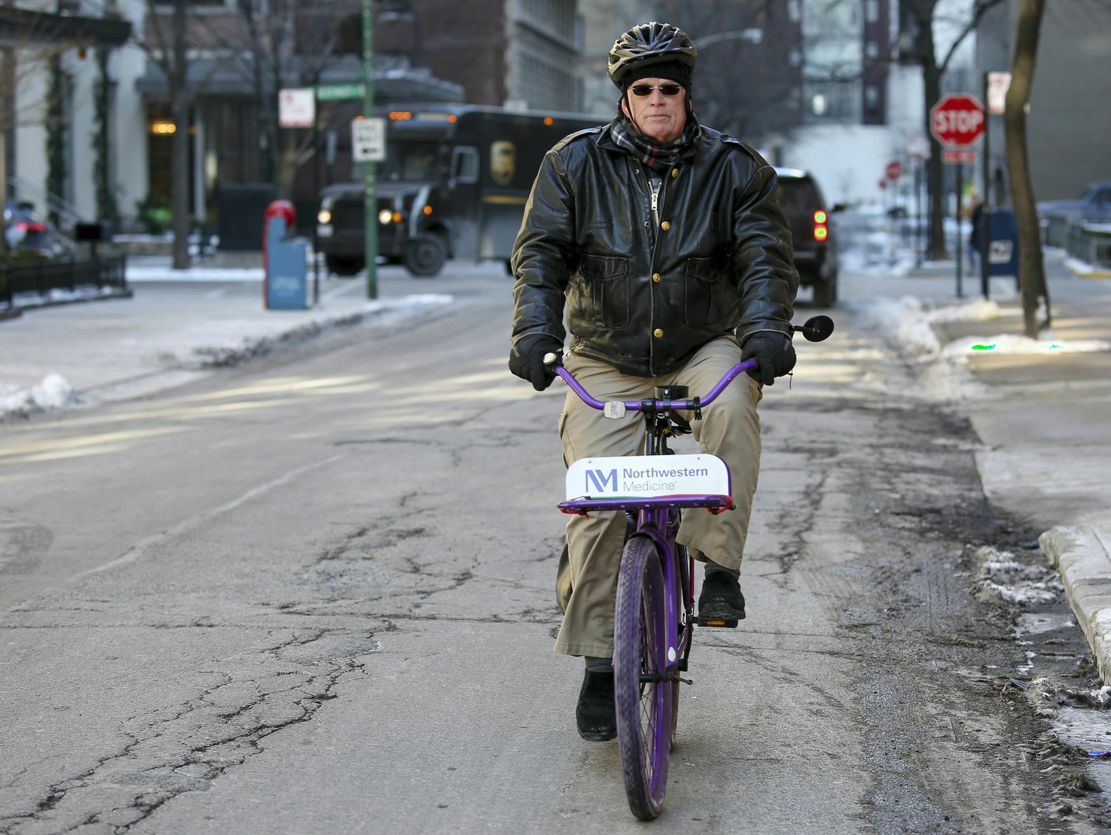 Nurse practitioner Dwayne Dobschuetz, rides his bicycle to visit an elderly patient at home in Chicago on Jan. 18, 2018. Dobschuetz makes several home visits a day for Northwestern Medicine to check vitals and answer questions with the goal of helping seniors stay healthier and out of the hospital. (AP Photo/Teresa Crawford)