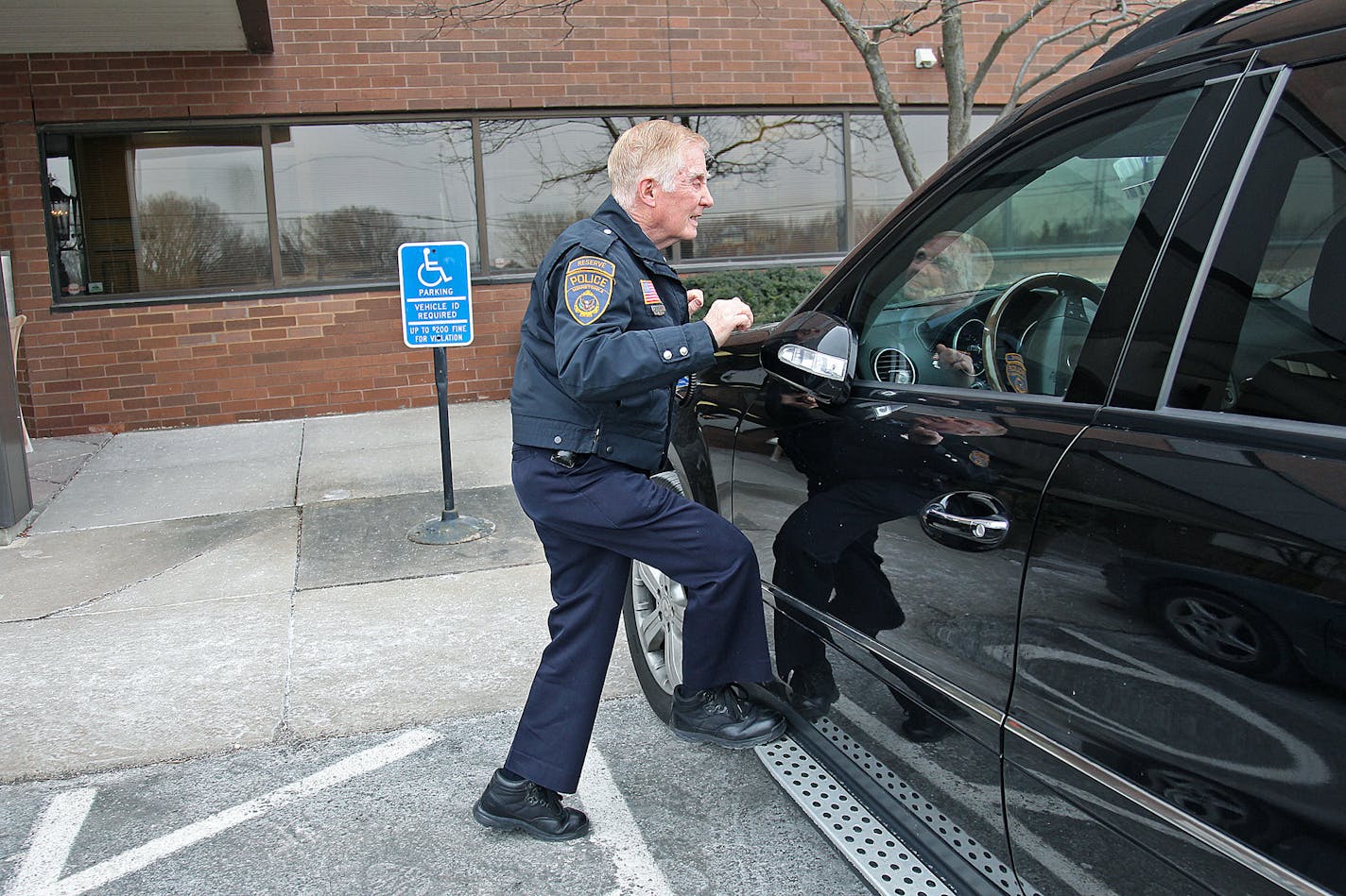 A Minnetonka officer inspected a car parked in a handicap spot.