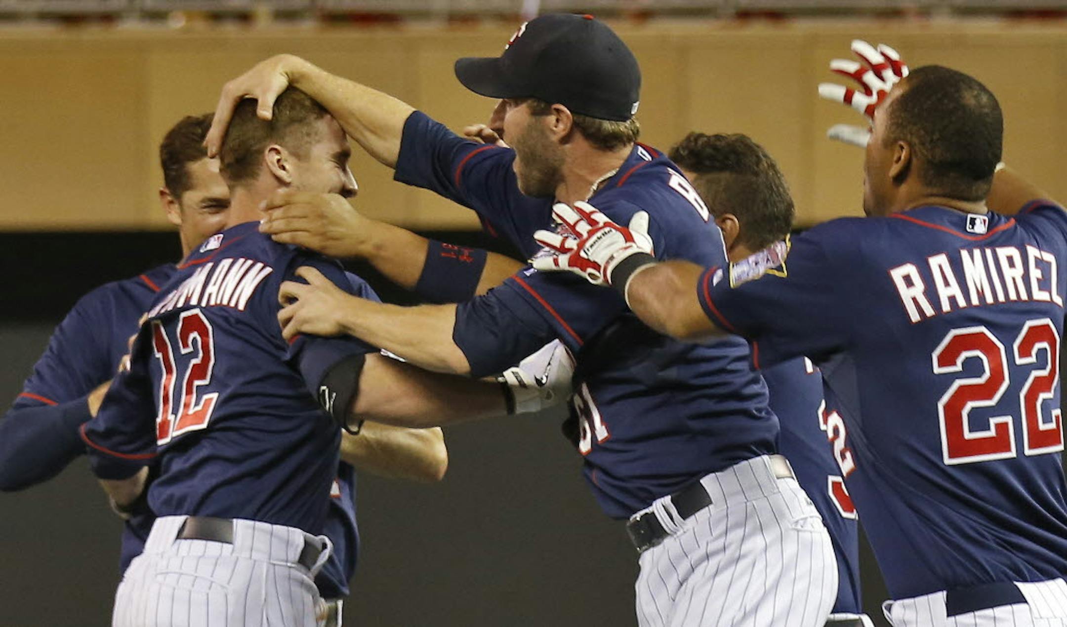 Teammates congratulated Chris Herrmann (12) after he knocked in the winning run in the ninth inning Thursday.