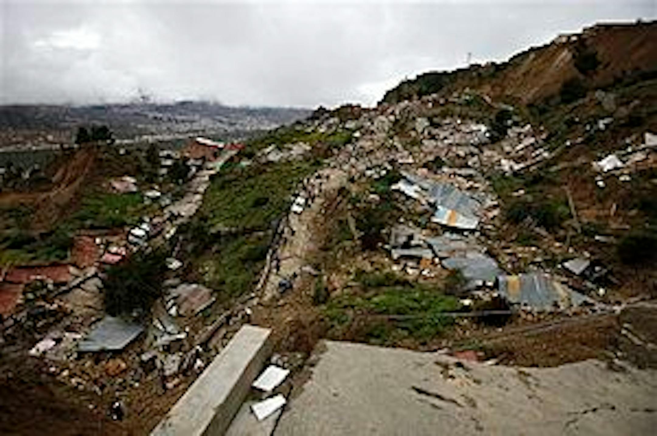 A panoramic view of an area of the Valle de Flores neighborhood in La Paz, Bolivia, where around 100 houses collapsed due to a landslide triggered by heavy rains Sunday, Feb. 27, 2011. (AP Photo/Juan Karita)