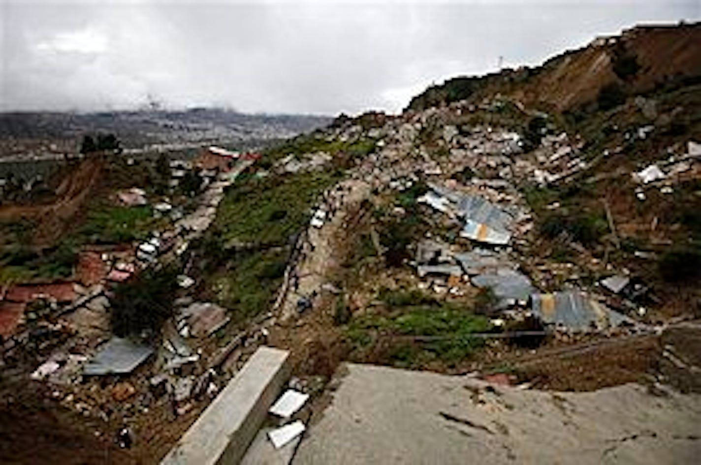 A panoramic view of an area of the Valle de Flores neighborhood in La Paz, Bolivia, where around 100 houses collapsed due to a landslide triggered by heavy rains Sunday, Feb. 27, 2011. (AP Photo/Juan Karita)