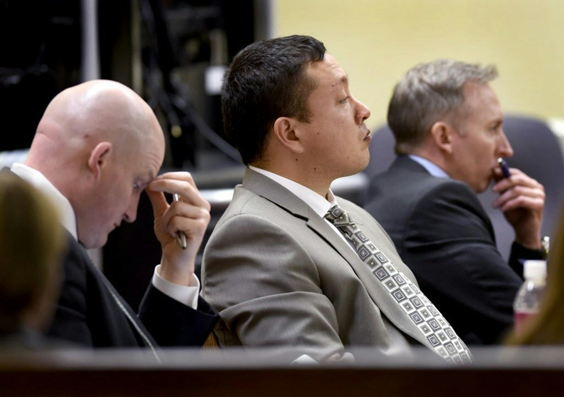 Markus Kaarma, center, is flanked by his defense attorneys Brian Smith, left, and Paul Ryan, as he listens to testimony, during his trial in Missoula, Montana.