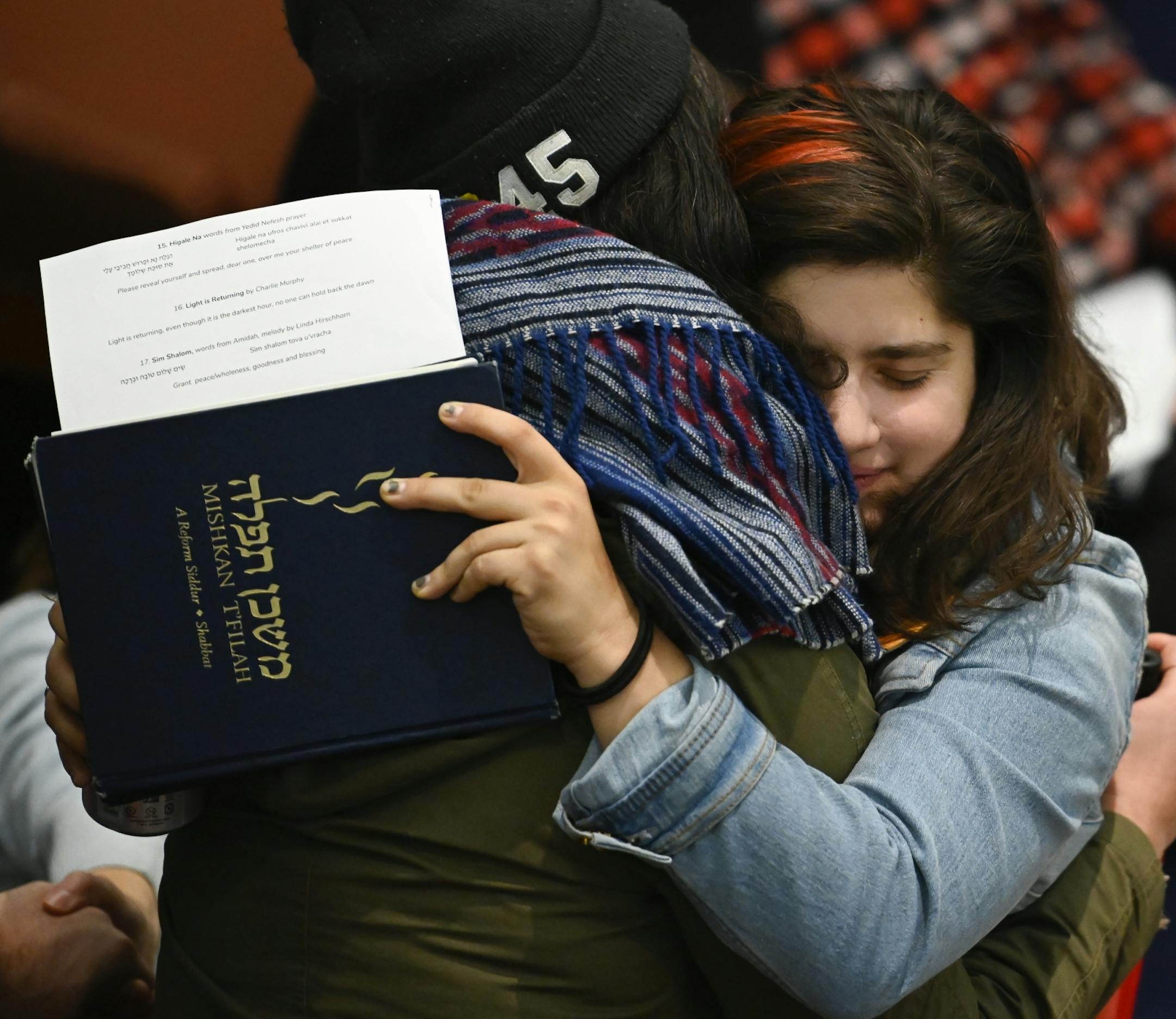 Temple goers embraced at Shir Tikvah Friday night before the start of services.