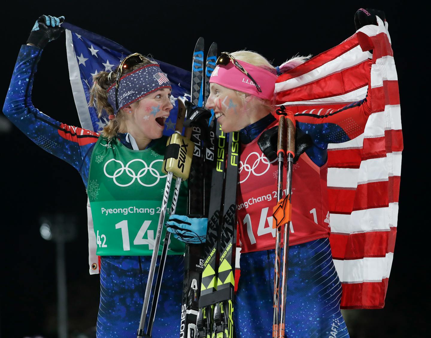 United States' Jessie Diggins, left, and Kikkan Randall celebrate after winning the gold medal in the women's team sprint freestyle cross-country skiing final at the 2018 Winter Olympics.