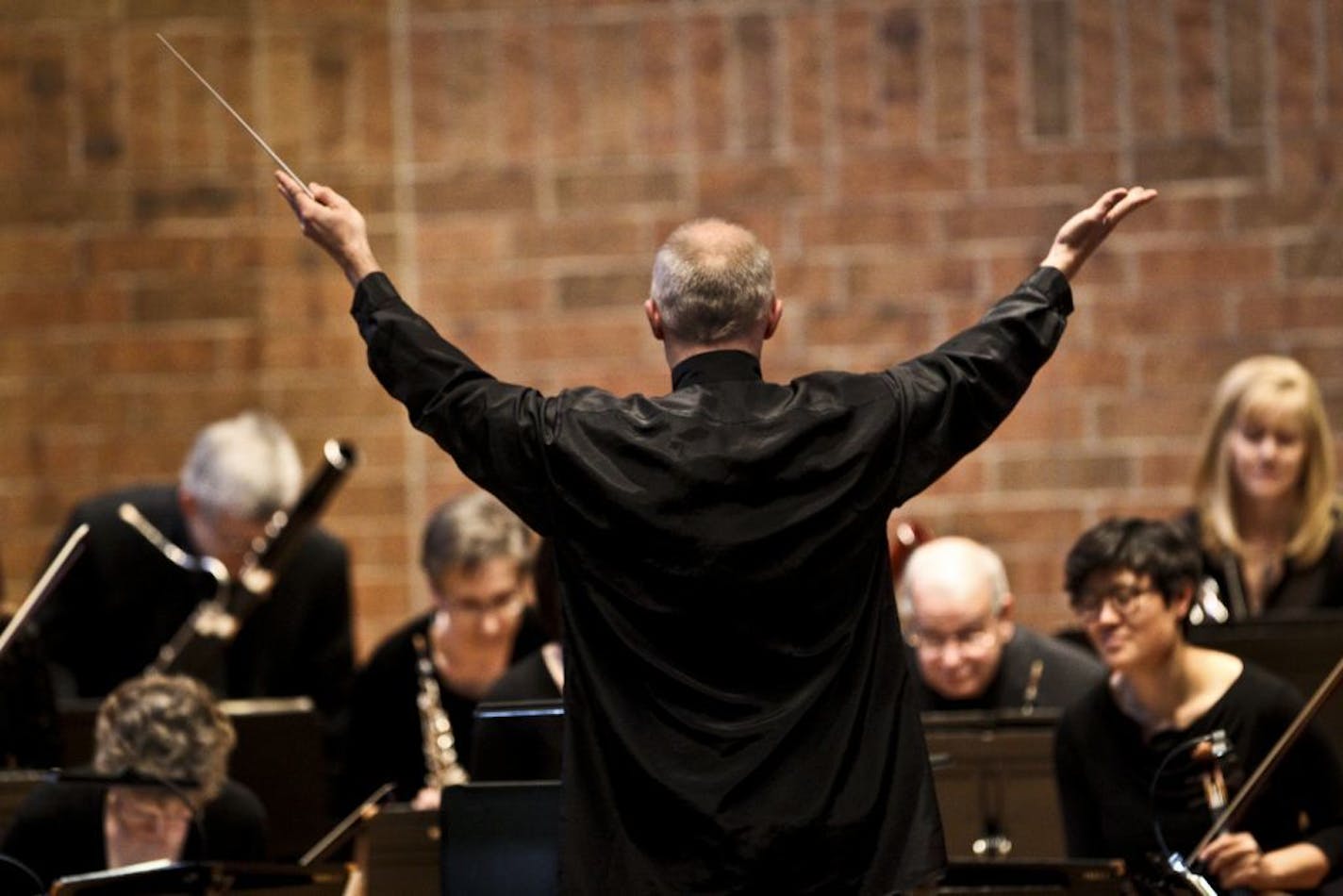 File photo: The St. Paul Chamber Orchestra conductor Thomas Zehetmair pointed to the musicians as people applauded the orchestra's return to the stage in 2013.