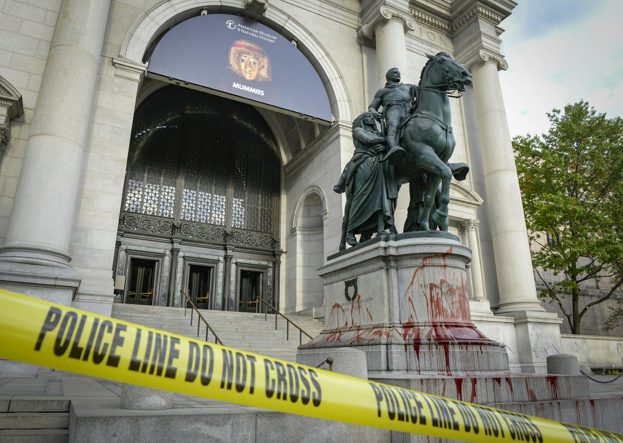 A police line is set up around the perimeter as NYPD investigate the scene where vandal splashes red paint on the Theodore Roosevelt statue on the steps of American Museum of Natural History located at Central Park West and West 79th Street in Manhattan on October 26, 2017.