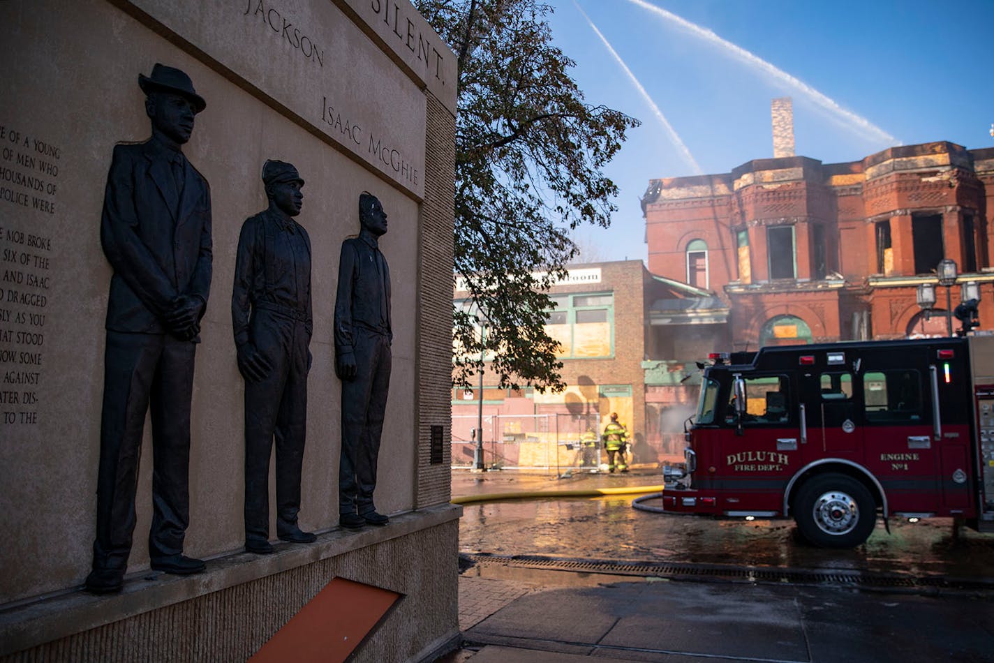 The Clayton Jackson McGhie Memorial stood witness as Duluth firefighters worked at putting out a fire at the former Paul Robeson Ballroom and Kozy Bar on Sunday morning.