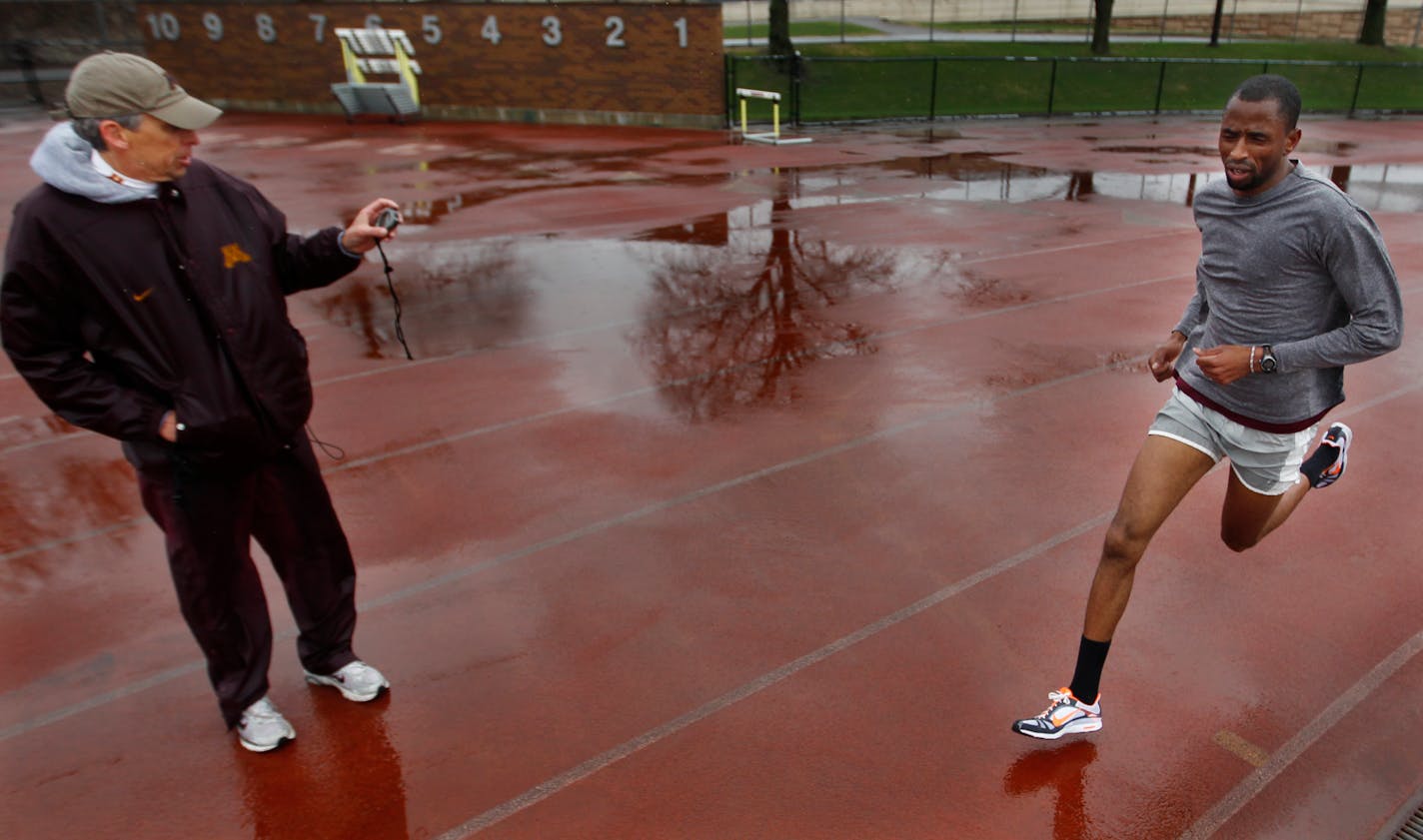 Coach Steve Plasencia times Hassan Mead in during sprints in 2011.