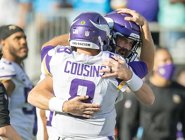 Vikings quarterback Kirk Cousins (8) celebrated with Vikings quarterback Nate Stanley (14) after his pass to Vikings wide receiver K.J. Osborn (17) in