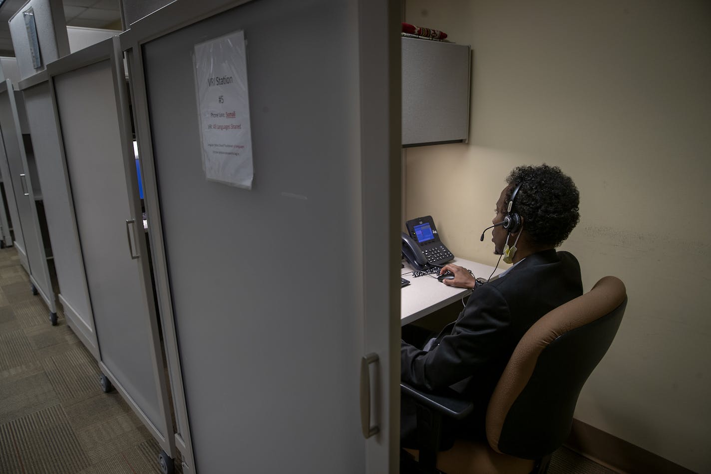 Interpreter Shafik Hassan took a call from a Somali language caller at the M Health Fairview call center, Wednesday, May 20, 2020 in Minneapolis.