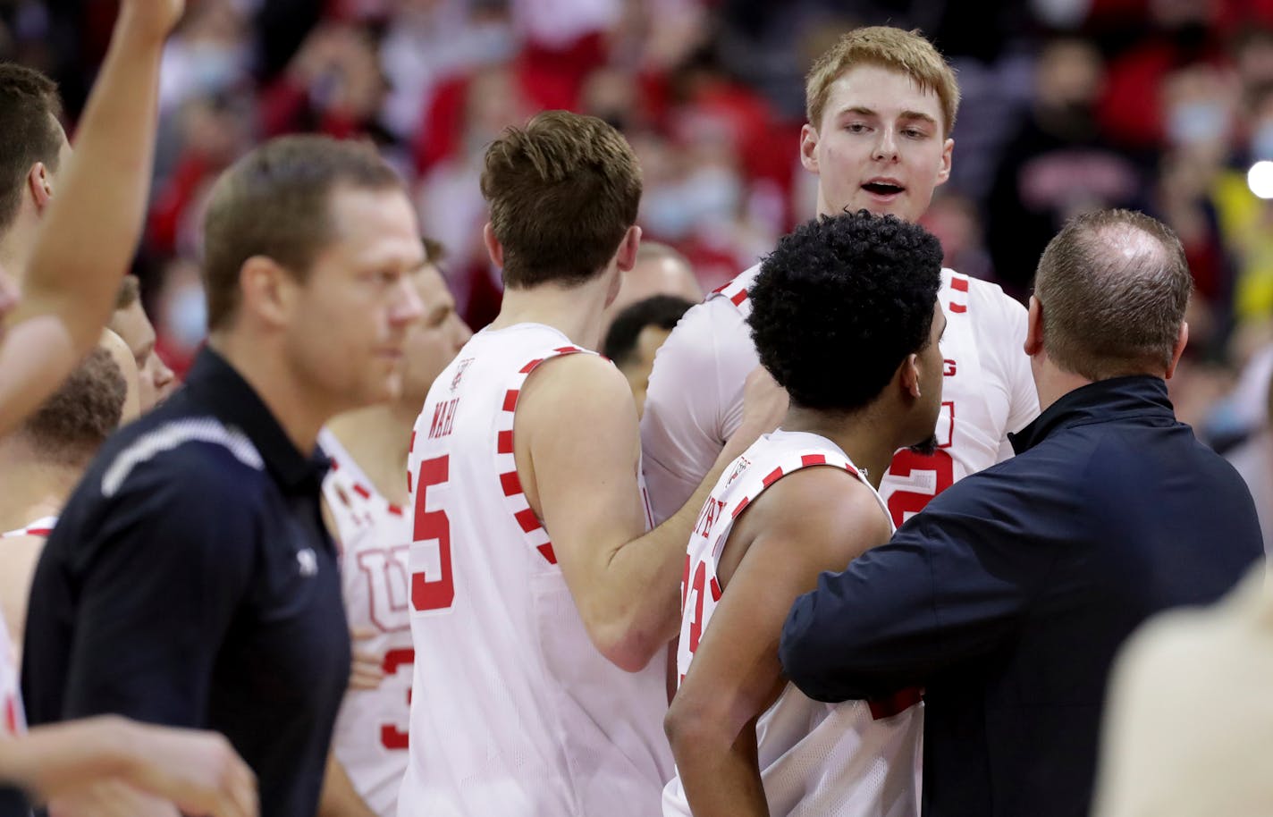 Wisconsin and Michigan players and coaches are involved in a scuffle with Michigan head coach Juwan Howard during the waning moments of an NCAA college basketball game Sunday, Feb. 20, 2022, in Madison, Wis. (Mark Hoffman/Milwaukee Journal-Sentinel via AP)