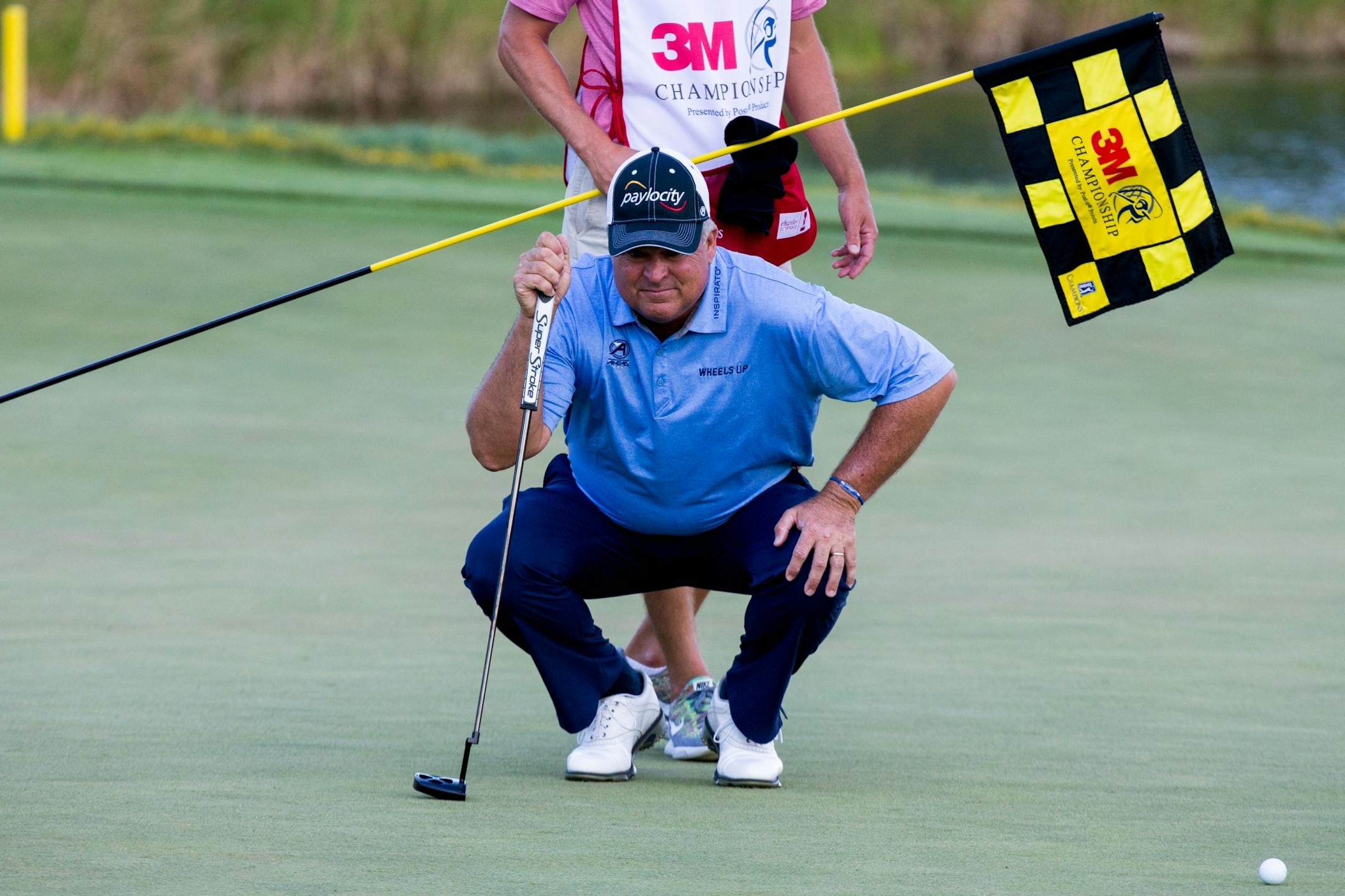 Kenny Perry takes a better look at the 18th hole before putting during round one of the 3M Championship. Perry and Mike Goodes are the two leaders after round one.