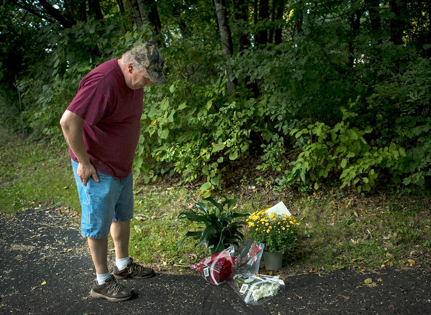 Brian Schulte, a neighbor of the Wetterlings, paused for a moment over a memorial at the end of the Wetterling's driveway Saturday evening. Schulte says he hopes the family can finally find closure now, "after all them years, they deserve it."