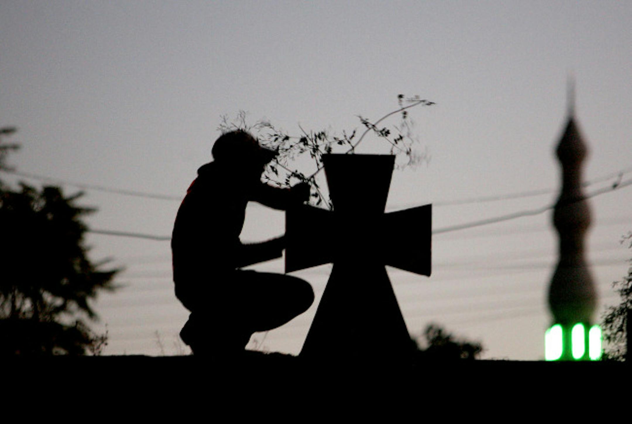 A Palestinian man arranges a tree branch above the steeple of the Latin Catholic church near the minaret of a mosque (R) in the West Bank village of Zababdah several kilometers from the city of Jenin, 10 December 2007, ahead of the Muslim feast of Eid al-Adha and Christmas. Christmas, the annual festival of the Christian church commemorating the birth of Jesus is celebrated every December 25. Muslims will celebrate Eid al-Adha, or feast of sacrifice marking the end of the Hajj or pilgrimage to M